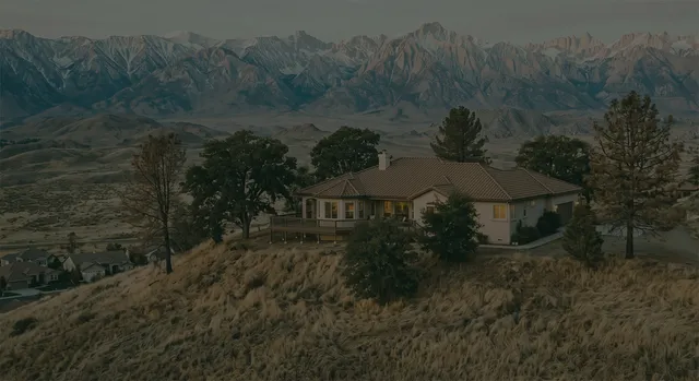 An umbrella sheltering a house, representing a last-resort insurance backstop
